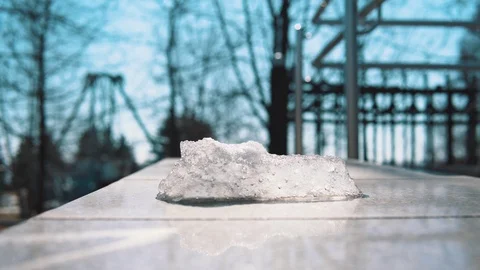 Piece of ice melts under hot sunbeams. Stock Footage 106376748