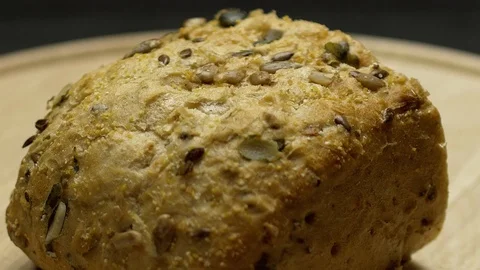 A piece of integral bread on a wooden board Stock Footage 117343661