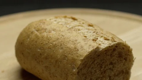 A piece of integral bread on a wooden board Stock Footage 117343683