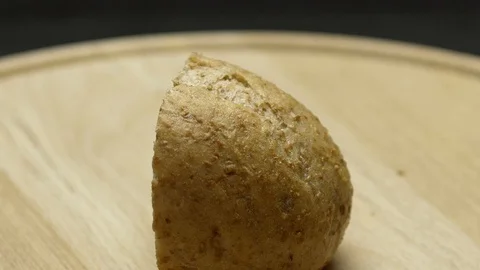 A piece of integral bread on a wooden board Stock Footage 117343714