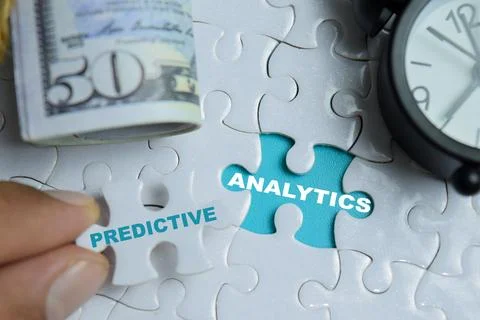 Piece of jigsaw puzzle predictive analytics phrase. Stock Photos