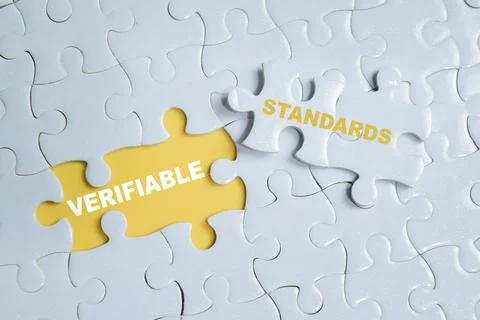 Piece of jigsaw puzzle with word variable standards. For compliance Stock Photos