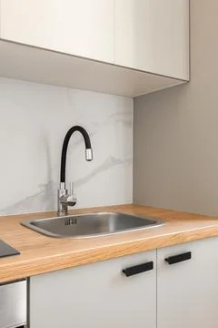 Piece of kitchen in gray solid colors with comfortable wall cabinets and modern Stock Photos