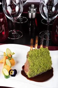 Piece of lamb rack with bone roasted with green herb, bread, sweet potatoes p Stock Photos