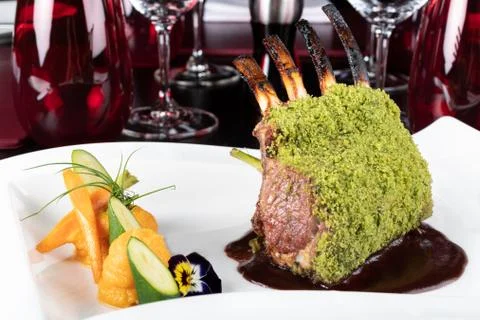 Piece of lamb rack with bone roasted with green herb, bread, sweet potatoes p Stock Photos