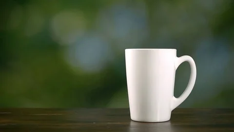 Piece of lemon drop in cup of hot water, super slow motion hd video Stock Footage 72466549