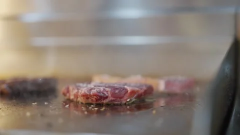 A piece of meat is being cooked on a grill Stock Footage 296056738