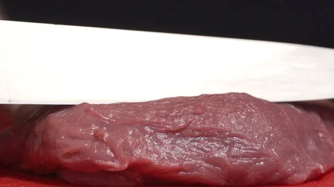 Piece of meat being sliced on a cutting board Stock-Footage 128822643