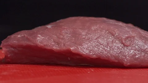 Piece of meat being thrown on a cutting board Video stock 128822033