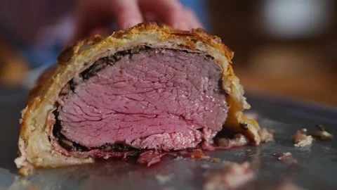 A piece of meat is cut open and is on a plate Stock Footage 295370866