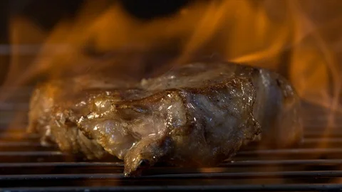 A piece of meat is fried in a grille Stock Footage 118134423