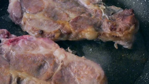 A piece of meat on a frying pan Stock Footage 101199740