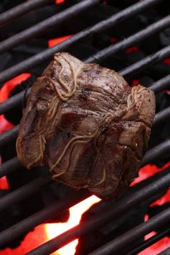 Piece of meat on the grill.Close up Stock Photos