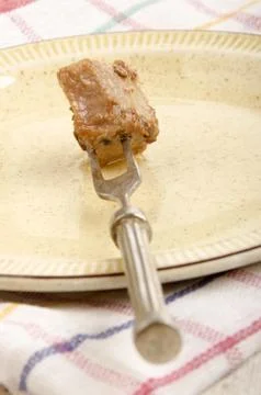 Piece of meat on a meat fork Stock Photos