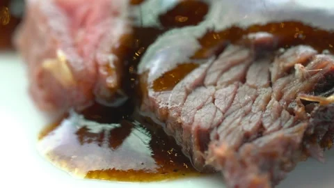 A piece of meat with sauce on it Stock Footage 313357178