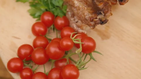 A piece of meat with tomatoes Stock Footage 122130585