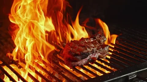 A piece of medium rare meat against the fire. Barbecue on the grill. Stock Footage 264413744