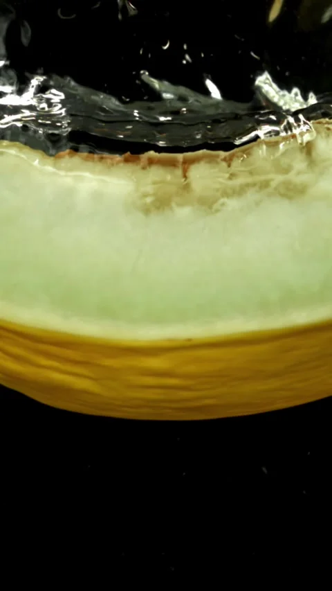 A piece of melon falls under the water. Filmed on a high-speed camera at 1000 Stock Footage 335370940