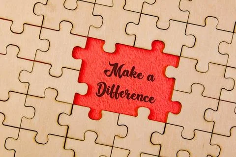 Piece missing from jigsaw puzzle with word Make a Difference Stock Photos