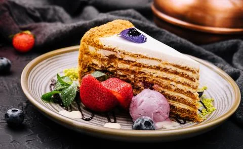 Piece of multi-layered cake decorated with mixed berries Stock Photos