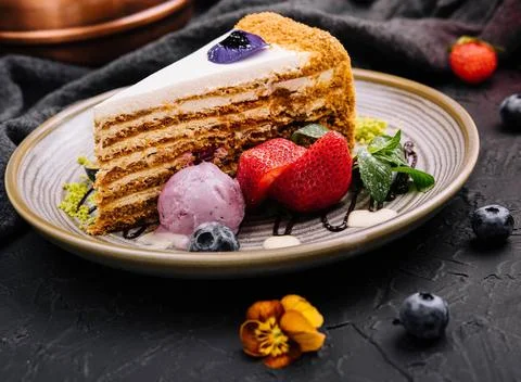 Piece of multi-layered cake decorated with mixed berries piece of multi-la... Stock Photos