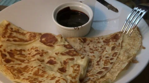 A piece of pancake is dipped in a sauce Stock Footage 90958650