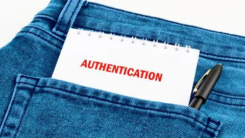 A piece of paper labeled AUTHENTICATION is placed in the back pocket of blue  Fotos de archivo