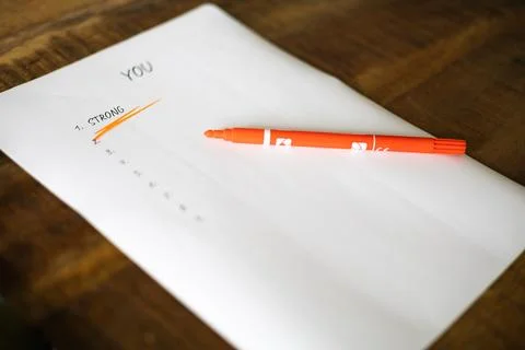 A piece of paper with a list of things to do and a red marker on top of it Stock Photos