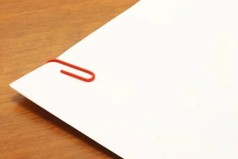 Piece of paper with a red clip on the table Stock Photos