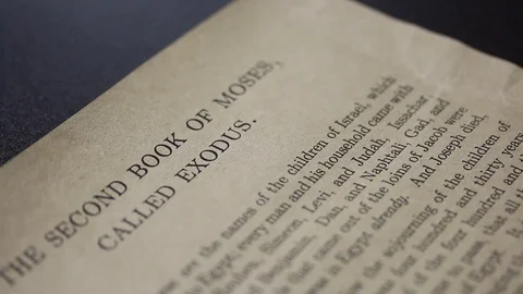 A piece of paper with the text of the first chapter of the Bible book of Exod Stock Footage 126543117