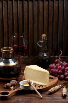 Piece of parmesan cheese served with grape and wine Stock Photos