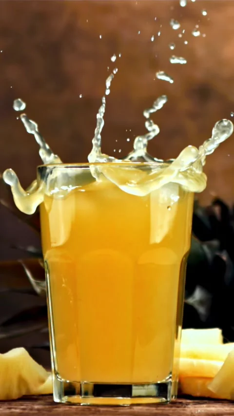 Piece of pineapple falls into pineapple juice. Filmed is slow motion 1000 fps Stock Footage 335291657