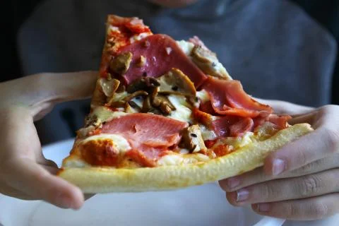 Piece of pizza in hands Foto stock