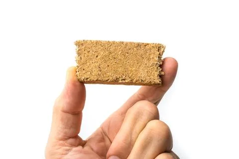 Piece of Plain Particle Board between fingers Stock Photos