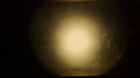 A piece of plastic in front of a glowing flashlight creates grunge background Stock Footage 145263138