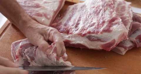 Piece of pork belly preparing using knife, close up Stock Footage 260510132
