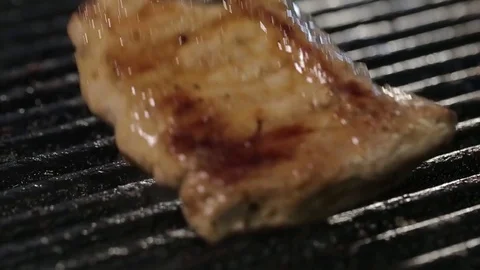 A piece of pork turn on the grill Stock Footage 75246068