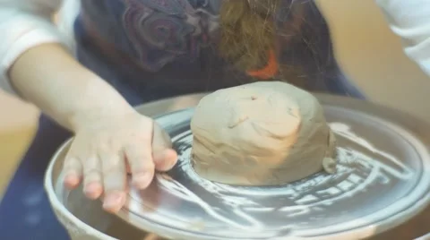 A Piece of Pot is Put on a Moving Pottery Wheel and Some Girl Tries to Shape it Stock Footage 59121839