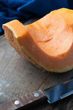 Piece of pumpkin on rustic background Stock Photos