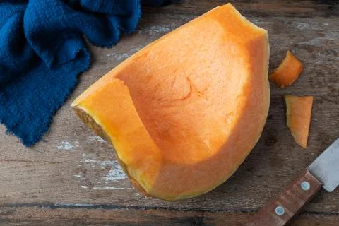 Piece of pumpkin on rustic background Stock Photos