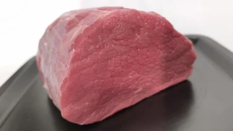 A piece of raw beef meat in close-up Stock Footage 316405061