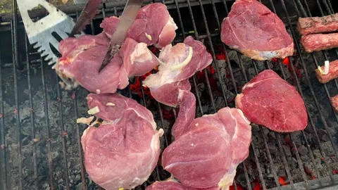 A piece of raw red meat is turned over to the other side Video stock 200493812