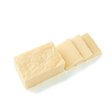 A piece of rectangular cheese without packaging. Several pieces have been cut Stock Photos