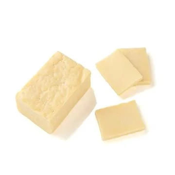 A piece of rectangular cheese without packaging. Several pieces have been cut Stock Photos