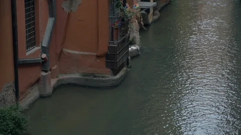Piece of river that flows through buildings in Bologna the city center in Italy Stock Footage 123154024