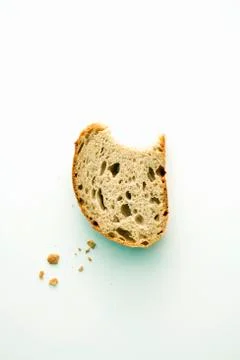 A piece of rye bread with a bite taken out Stock Photos