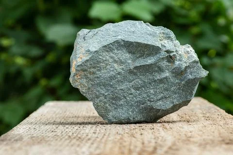 A Piece of Slate Metamorphic Rock Sample on Wood Stock Photos
