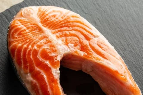 Piece of smooth red fish being uncooked and looking fresh Stock Photos