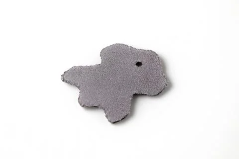 A piece of split leather and nubuck in the shape of a symbol of genuine lea.. Stock Photos