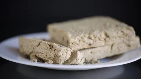 Piece of sweet halva on black background Stock Footage 150184583